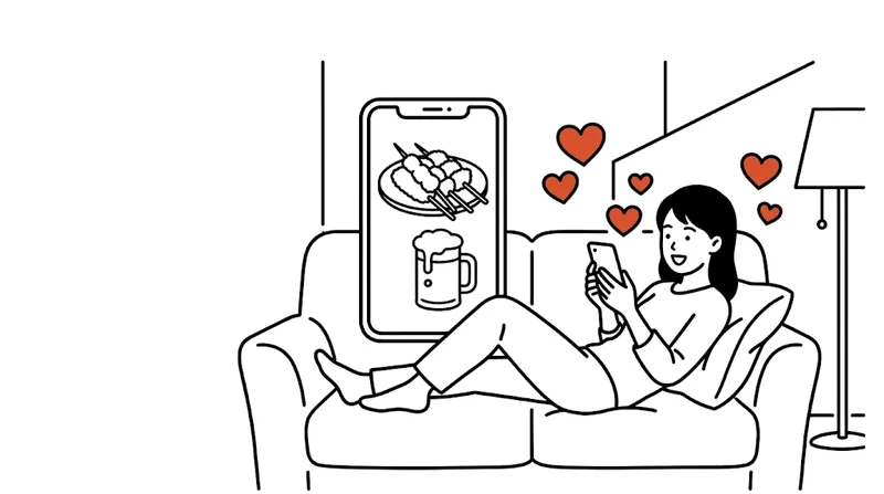 ソファでくつろぎながら、スマホで料理の縦型動画を見ている女性